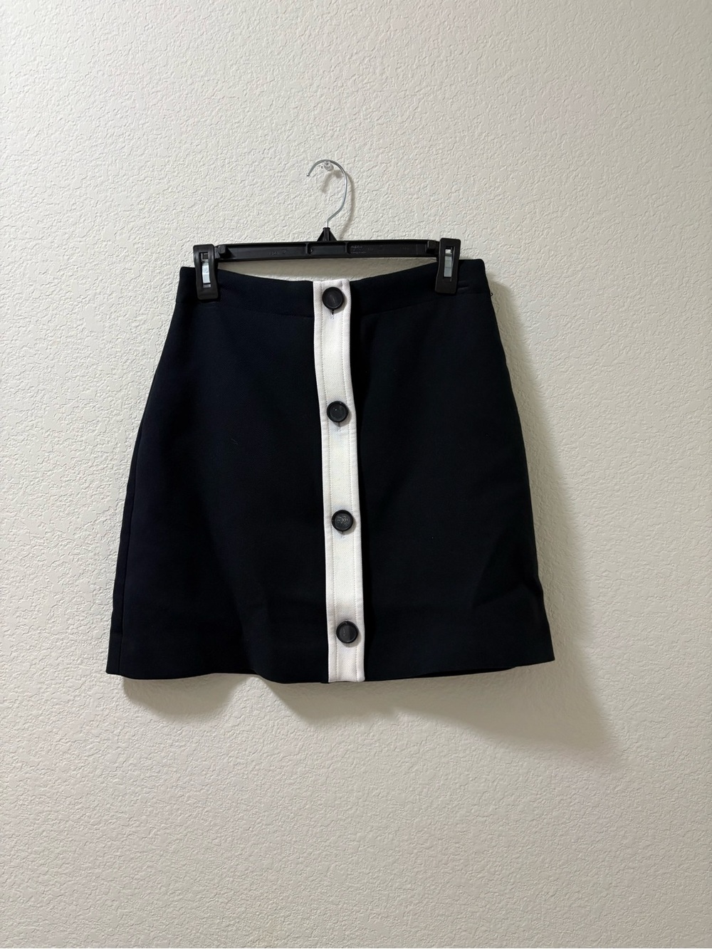 Kate Spade New York black mini skirt with white placket and buttons. Size 4 NWOT